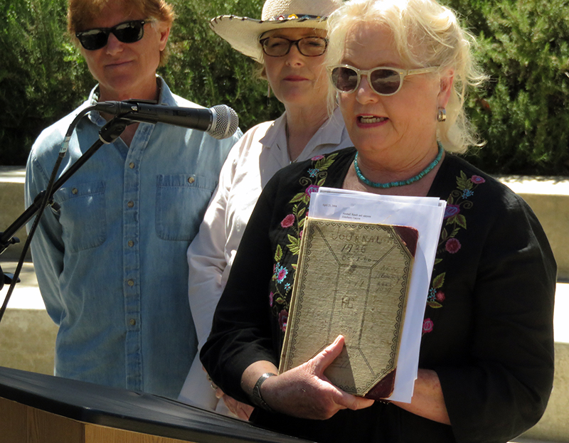 Lily Carey shows her grandfather's ledger book