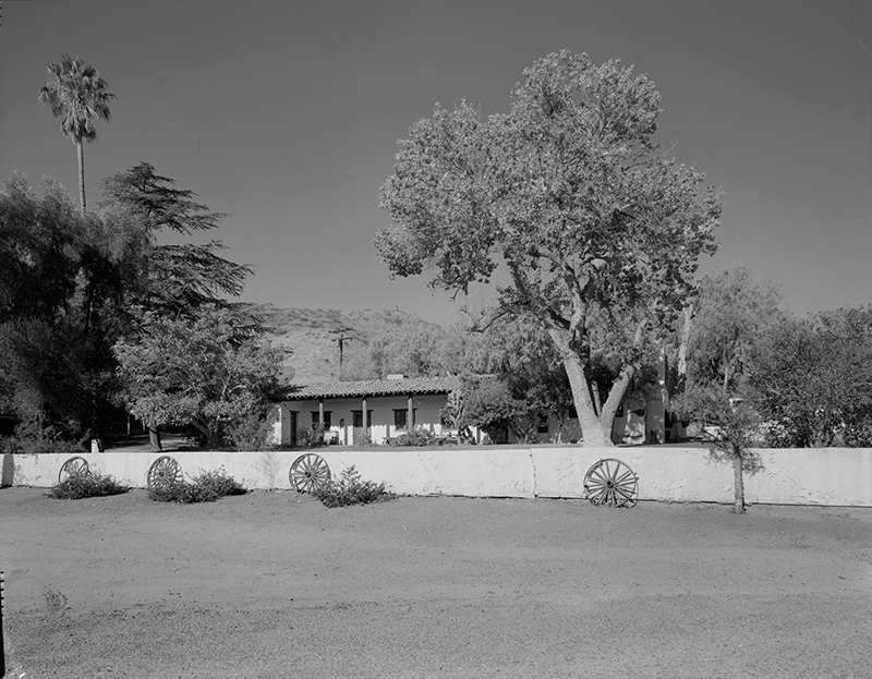 GENERAL VIEW OF BUILDING 5 FROM DRIVEWAY, SHOWING FRONT PORCH AND FENCE; CAMERA FACING WEST