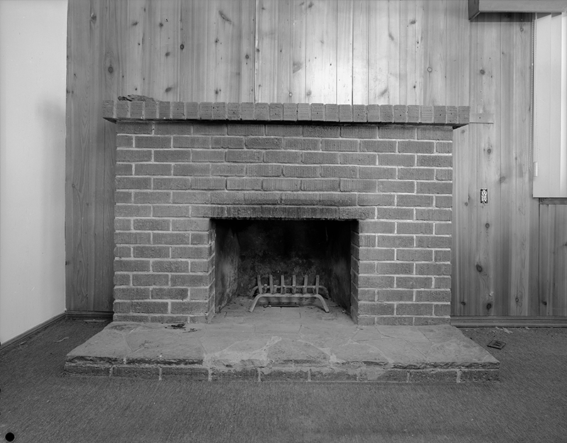 Detail shot of fireplace located on north wall of living room, view facing north.
