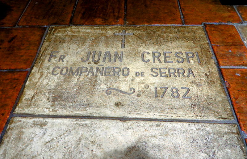 Fr. Juan Crespi is entombed in a crypt beneath his  headstone next to the altar.
